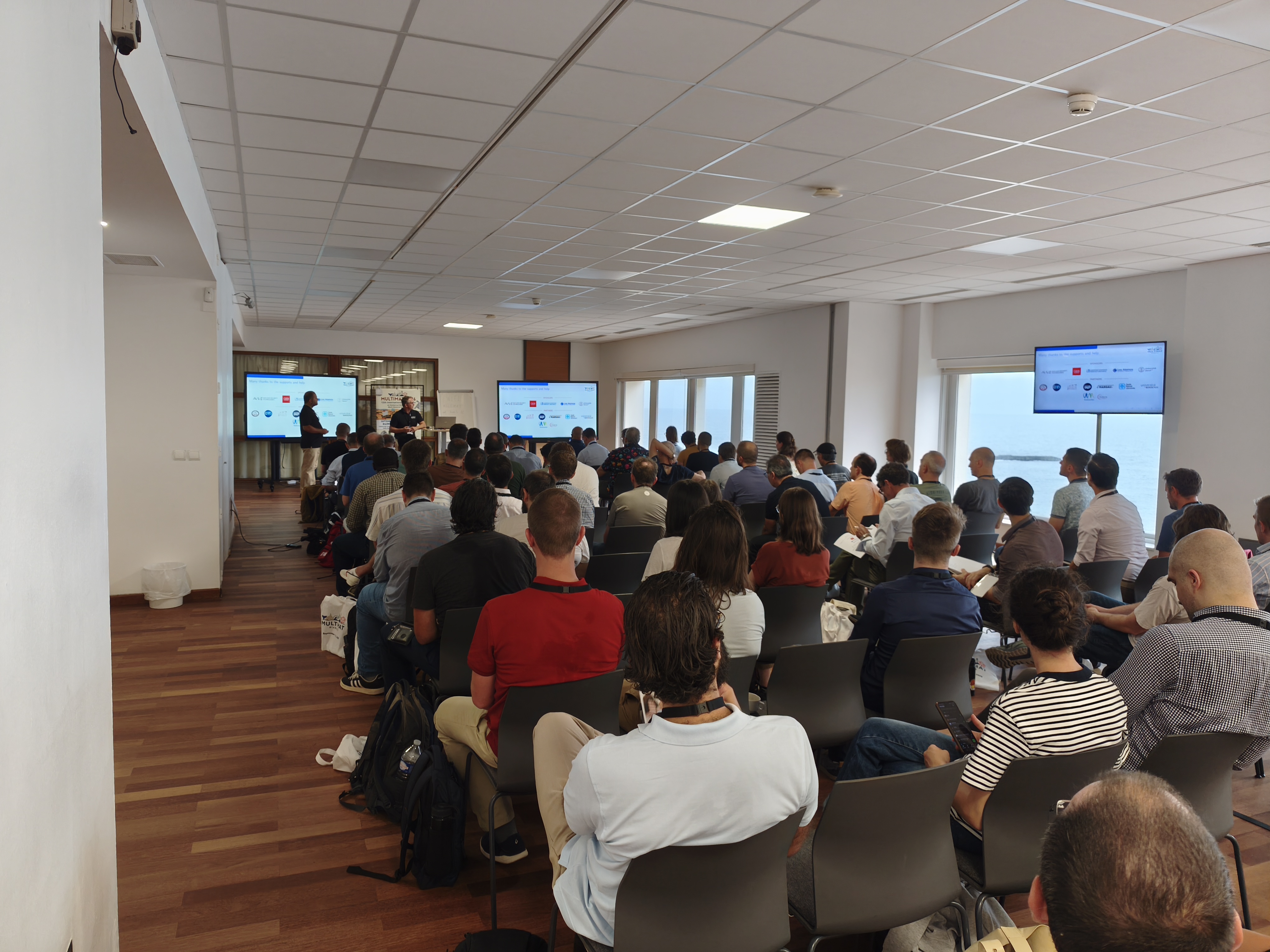 Audience attending a presentation at the Multimat conference